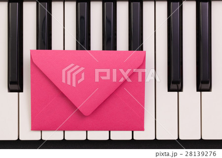 Funny arrangement envelope on the piano keybords 28139276