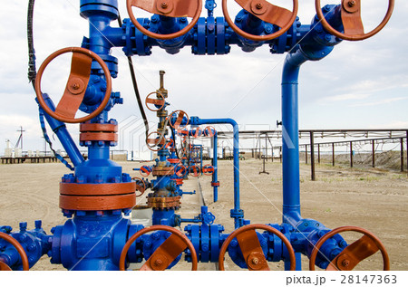 Group of wellheads. Oilfield with sand ground.  28147363