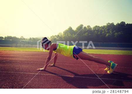 young woman runner practice push up on track 28148794