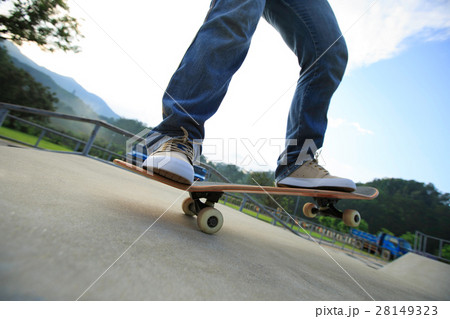 young skateboarder legs skateboarding at skatepark young skateboarder legs skateboarding at skatepark 28149323