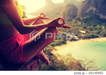 young woman practice yoga at mountain peak cliff 28149992