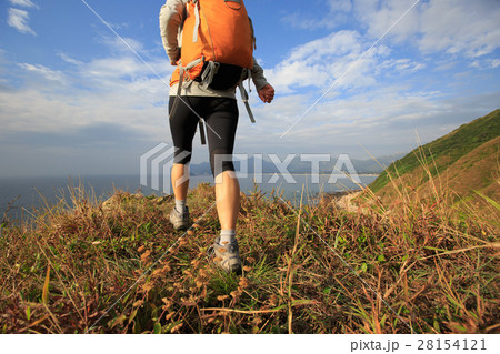successful hiker walking on seaside mountain peak 28154121