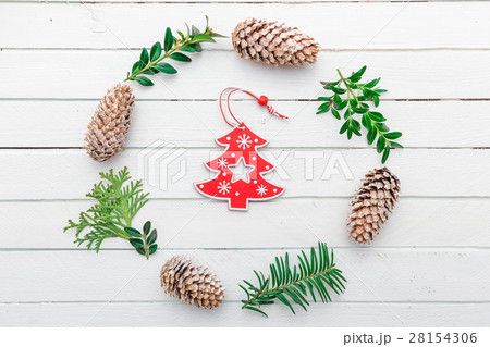 Wreath with natural decorations hanging on a white Wreath with natural decorations hanging on a white 28154306