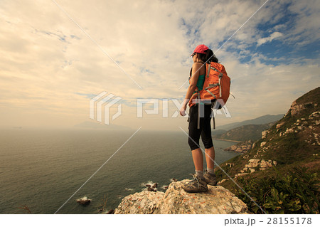 successful hiker hiking on seaside mountain peak successful hiker hiking on seaside mountain peak 28155178
