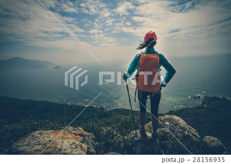 successful hiker on seaside mountain peak rock 28156935