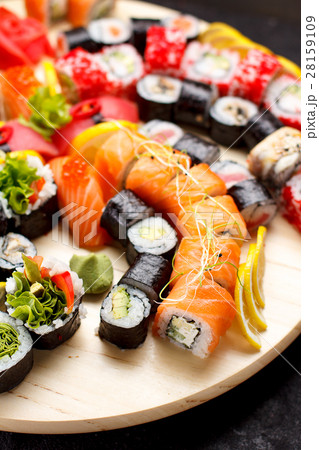 Sushi set on a wooden plate and black concrete  28159109