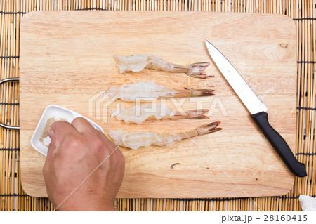 Chef cooking raw shrimp with salt and pepper Chef cooking raw shrimp with salt and pepper 28160415