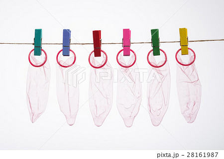 Unrolled latex condoms on white background 28161987