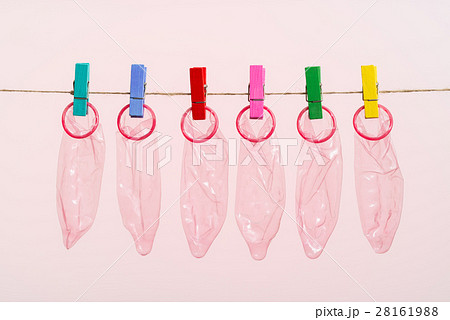 Unrolled latex condoms on white background Unrolled latex condoms on white background 28161988