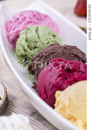 A ball of chocolate ice cream among other multi-co 28164636