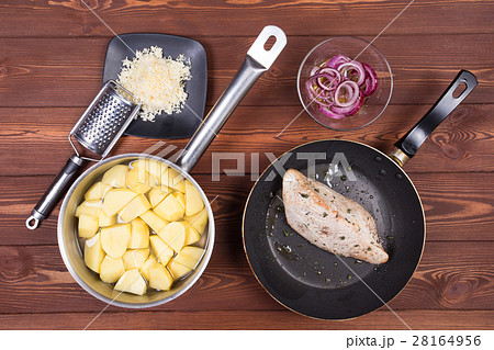 Wooden spoon and ingredients on dark background Wooden spoon and ingredients on dark background 28164956
