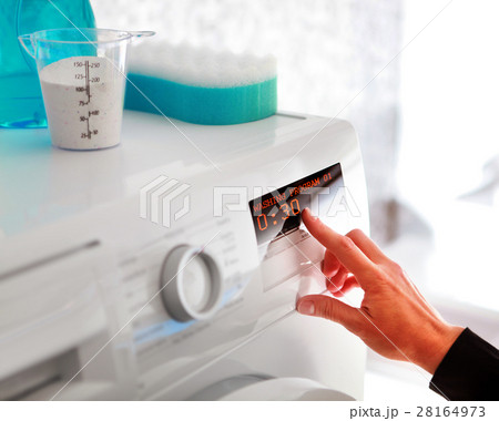 woman choosing program for washing woman choosing program for washing 28164973