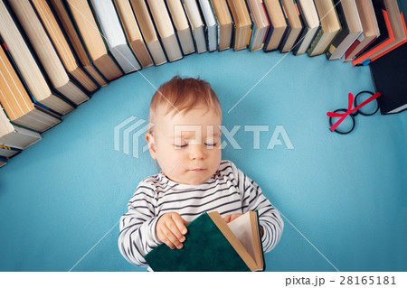 One year old baby with spectackles and books 28165181