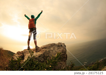 successful hiker hiking on seaside mountain peak 28175125