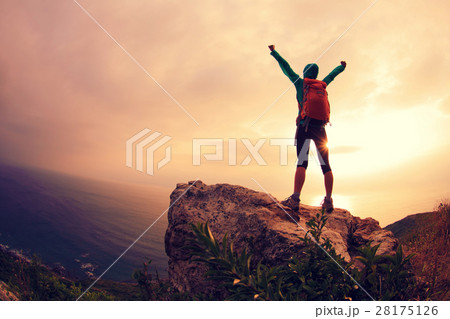 successful hiker hiking on seaside mountain peak 28175126