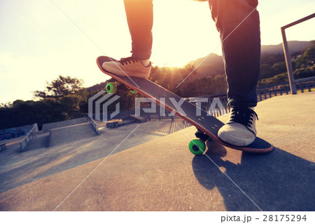 skateboarder legs riding skateboard at skatepark 28175294