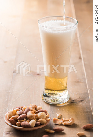 Cold beer with cocktail nut on wood 28175464