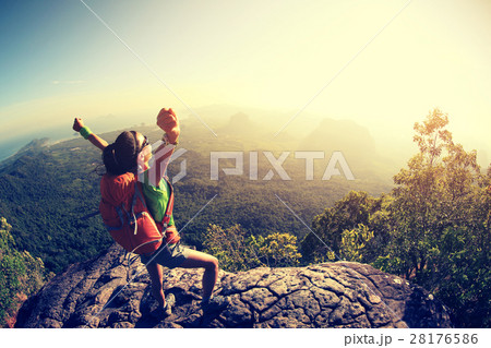 successful hiker hiking on seaside mountain peak successful hiker hiking on seaside mountain peak 28176586