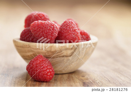 wood bowl full of ripe raspberries on old wooden table wood bowl full of ripe raspberries on old wooden table 28181276