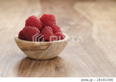 ripe organic raspberries in wood bowl on old wooden table ripe organic raspberries in wood bowl on old wooden table 28181306