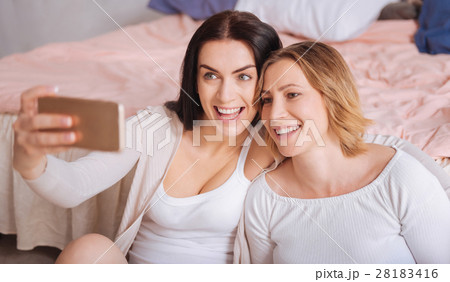 Expressive young ladies posing for a selfie Expressive young ladies posing for a selfie 28183416