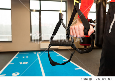 TRX. Male hands with fitness TRX straps in gym. TRX. Male hands with fitness TRX straps in gym. 28184101