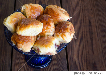 Homemade сakes with a cherry in a blue glass vase. Homemade сakes with a cherry in a blue glass vase. 28185770