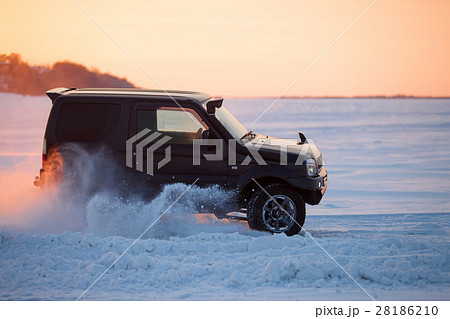 Suzuki Jimny moving on ice at sunset 28186210