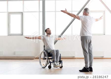 Handsome disabled man training in the gym with the 28186247