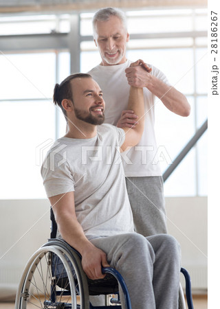 Skilled orthopedist exercising with handicapped in 28186267