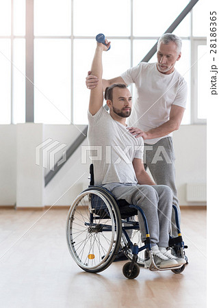 Athletic disabled man training with the coach in 28186365