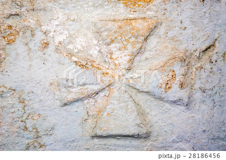 Maltese cross on stone wall 28186456