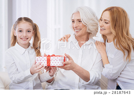 Cheerful femily members holding present 28187643