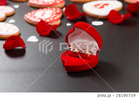 Beautiful red roses petals and wedding rings Beautiful red roses petals and wedding rings 28190739