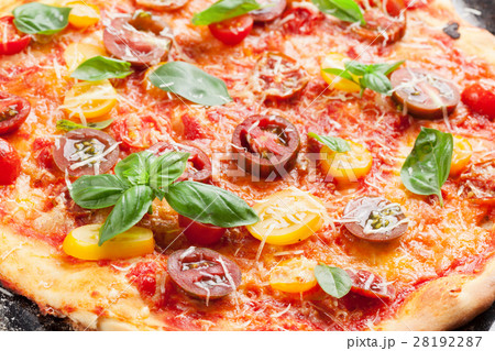 Homemade pizza with tomatoes, mozzarella and basil Homemade pizza with tomatoes, mozzarella and basil 28192287