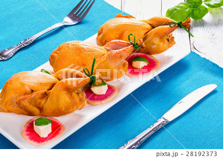 smoked quail on a rectangular dish, close-up 28192373