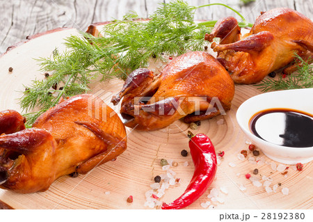 grilled quails on a spit with spices, close-up grilled quails on a spit with spices, close-up 28192380