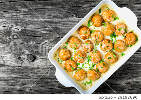 meatballs smothered in a creamy gravy sauce 28192690