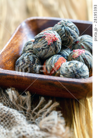 Wooden bowl with a flowering Chinese tea close up. Wooden bowl with a flowering Chinese tea close up. 28195393