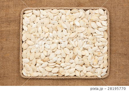 Frame made of rope with pumpkin seeds on sackcloth 28195770