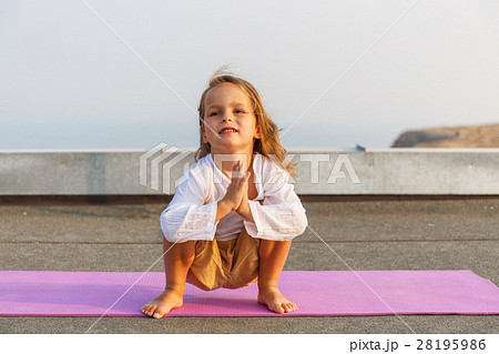 Baby doing yoga on the roof 28195986