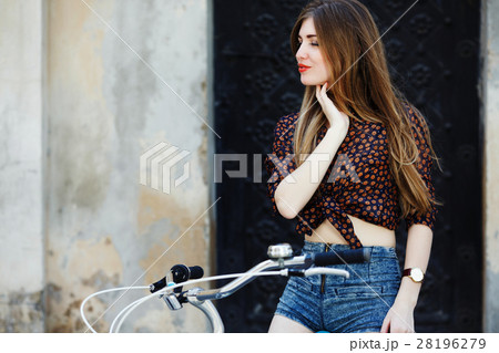 Attractive girl with long hair is sitting on the 28196279