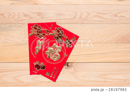 Chinese Red Envelope use in Chinese new year festival on wooden background. Translation in English meaning lucky and richly Chinese Red Envelope use in Chinese new year festival on wooden background. Translation in English meaning lucky and richly 28197983
