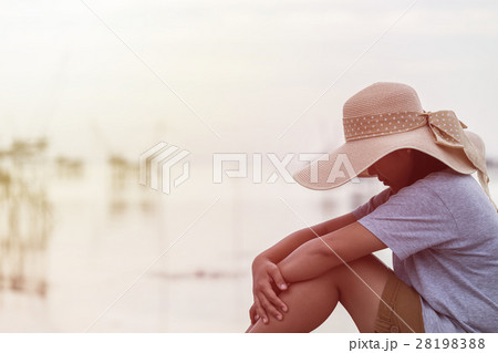 Backside of woman with big hat on the bridge and sunrise 28198388