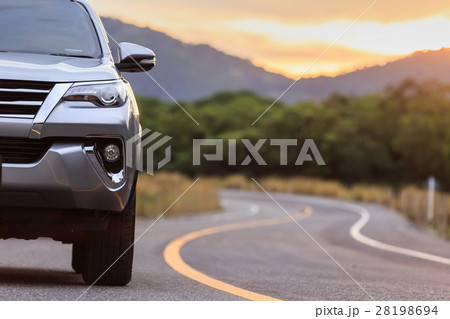 Close up front of new silver SUV car parking on the asphalt road 28198694