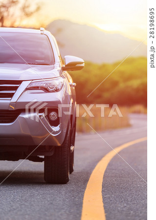 Close up front of new silver SUV car parking on the asphalt road 28198695