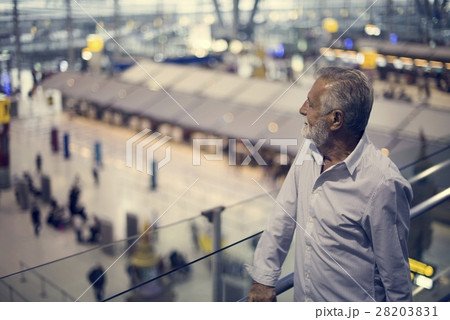 Man staring at the airport crowd downstairs Man staring at the airport crowd downstairs 28203831