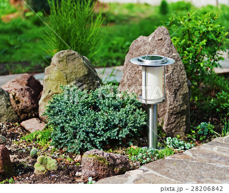 Solar-powered lamp on garden background.  28206842