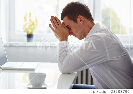 Man in a polo shirt stands leaning on railing Man in a polo shirt stands leaning on railing 28208796