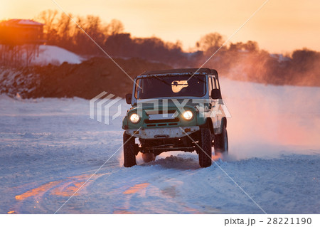Russian UAZ 469 moving on ice at sunset Russian UAZ 469 moving on ice at sunset 28221190